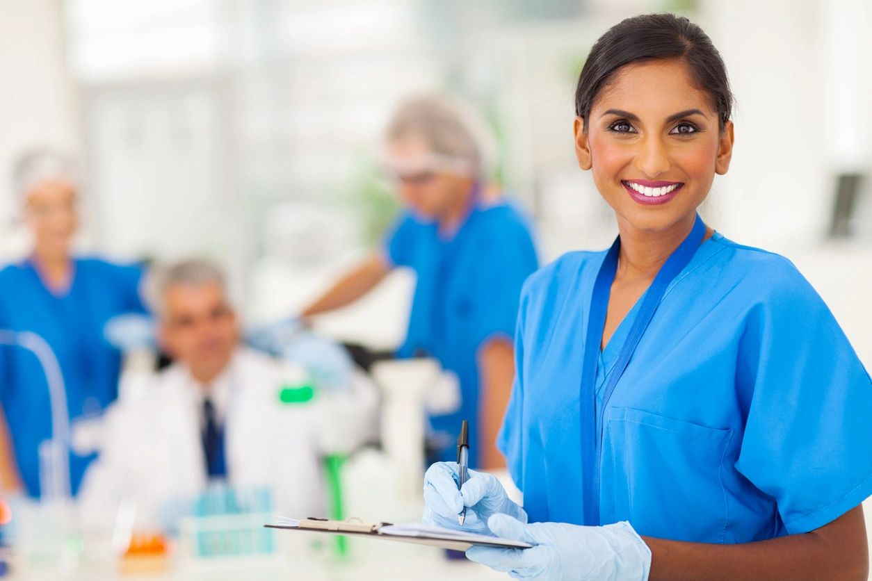 smiling nurse holding a clipboard